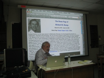 David starts his lecture by showing the website of Richard Skemp, his supervisor, who is therefore the academic great-grandfather of the students of A