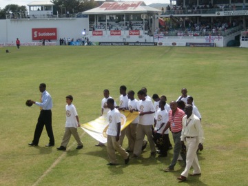 Viv Richards and Andy Roberts walk around the field (front right)